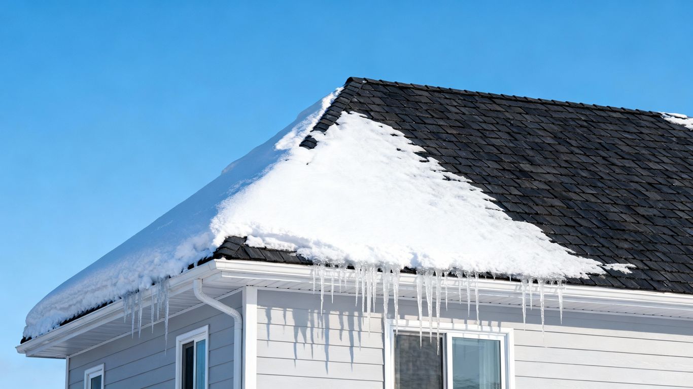 Snowy house with a safe, winter-ready roof.