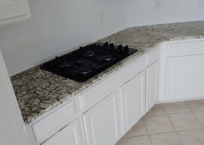 granite counter tops with new stove top after renovation