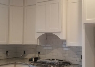 Freshly painted kitchen interior with updated finishes after home restoration.