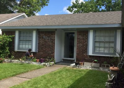 Updated exterior of a single-story brick home after renovation.