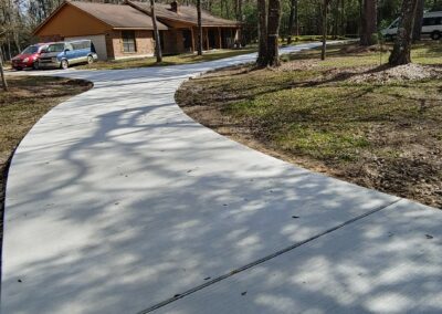 Newly poured concrete driveway at a residential home, smooth finish after construction.