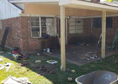 patio enclosure under construction during exterior restoration