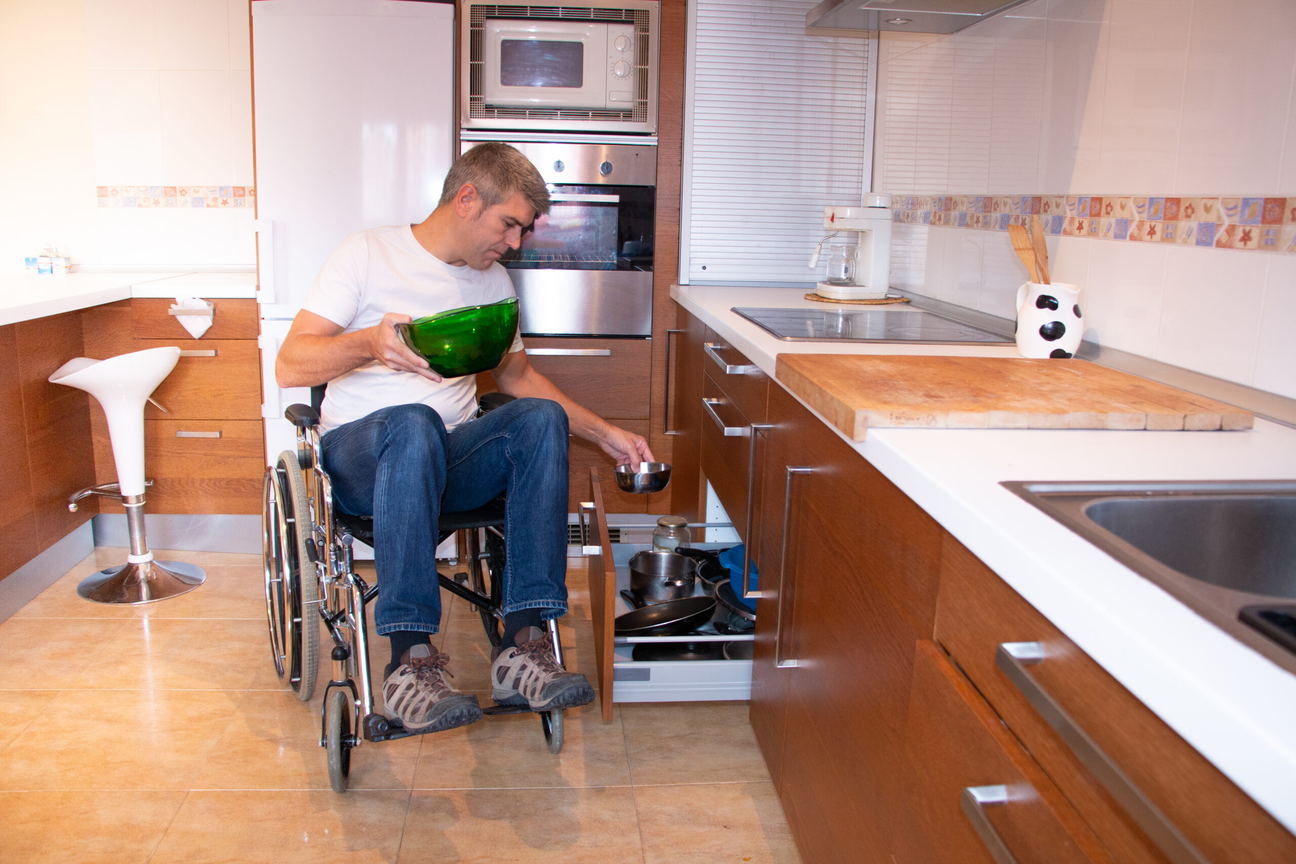 A,Man,In,A,Wheelchair,Preparing,Food,In,The,Kitchen.