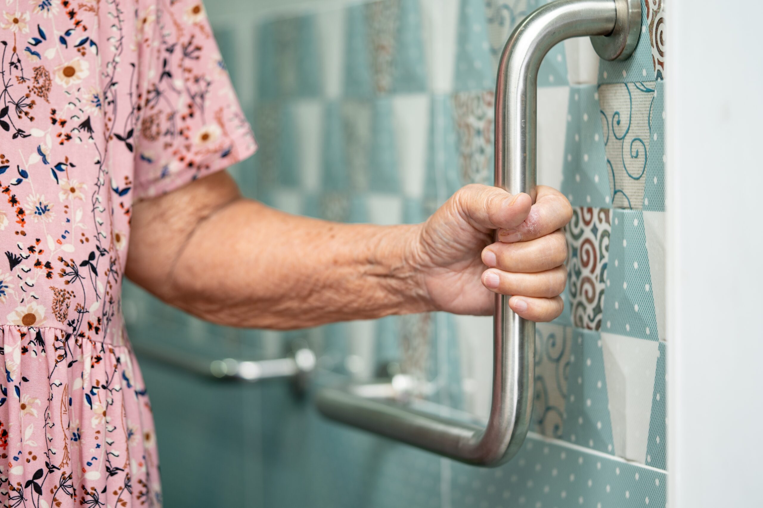 woman holiding handle bar in shower for CAPS and senior living