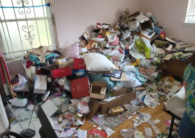 guest room with hoarding conditions before cleanup