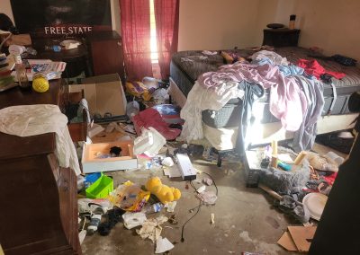 bedroom with hoarding conditions before cleanup